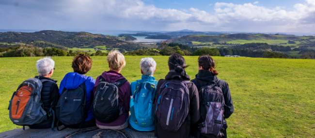 A group of Te Ara Hura walkers stop to take a break and admire the view | Gabrielle Young